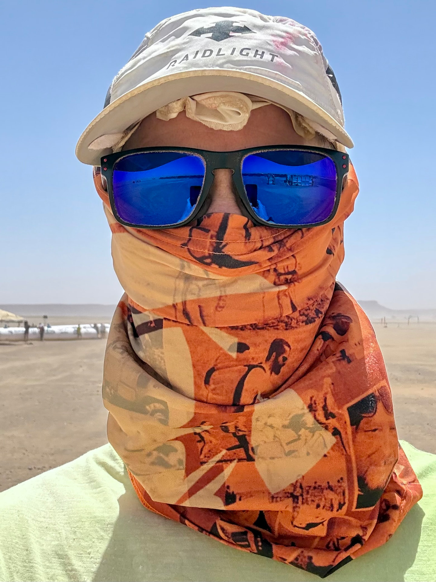 Derrick Tate wrapped in a buff, cap and sunglasses in the Sahara at the MDS bivouac